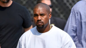 Kanye West Stares Down Paparazzi While Stepping Out In Swastika T-Shirt